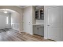 Bright foyer with wood floors, classic wainscoting, gray beverage center, and a convenient coat closet at 327 Happy Valley Dr., Myrtle Beach, SC 29588