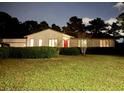 Charming home at twilight featuring a red front door and neatly manicured landscaping providing great curb appeal at 3774 Annandale Dr., Myrtle Beach, SC 29577