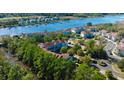 An elevated view of the condo building with a waterway in the background and the surrounding community at 4601 Greenbriar Dr. # 205A, Little River, SC 29566