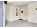 A bright and inviting entrance hall that leads into a condo, complete with a storm door for added security at 4601 Greenbriar Dr. # 205A, Little River, SC 29566