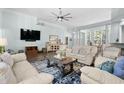 Open living room with hardwood floors, a ceiling fan, and light blue paint at 5012 Lindrick Ct., Myrtle Beach, SC 29579