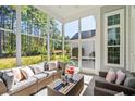 Screened-in back porch featuring outdoor furniture and view of the backyard at 5012 Lindrick Ct., Myrtle Beach, SC 29579