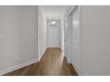 Bright hallway with wood-look flooring, leading to the front door of the house at 2441 Campton Loop, Conway, SC 29527