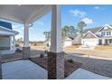 Inviting front porch featuring brick columns, an open view, and new landscaping at 2472 Campton Loop, Conway, SC 29527