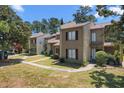 Well-manicured townhomes with a charming sidewalk and beautiful trees providing ample shade at 1100 Wedge Way # 67, Little River, SC 29566