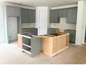 Spacious kitchen featuring gray cabinetry, ample storage, and a blank canvas for customization with a large island at 314 Hollywood Dr. S, Surfside Beach, SC 29575