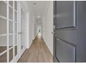 Inviting hallway features wood-look floors and glass paneled doors leading to additional rooms at 1044 Jase Dr., Longs, SC 29568