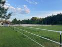 Outdoor riding arena with jumps and white vinyl fencing at 1692 S Morgan Ave., Andrews, SC 29510