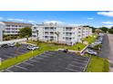 Exterior of a three-story condo building with a large parking area and landscaping at 191 Maison Dr. # B203, Myrtle Beach, SC 29572