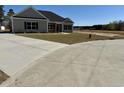 A large concrete driveway leading up to an inviting single-story home, highlighting outdoor space at 217 Shady Pines Ct., Conway, SC 29527