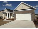Charming single-story home featuring a two-car garage and neutral-colored siding and brick accents at 1009 Jase Dr., Longs, SC 29568