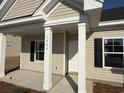 Inviting front porch with white columns and black shuttered windows offers curb appeal at 1009 Jase Dr., Longs, SC 29568