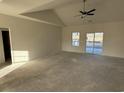 Unfinished living room with ceiling fan, and sliding glass door to backyard at 1009 Jase Dr., Longs, SC 29568