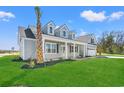 Beautiful home with a green lawn and palm tree in the front yard at 1101 Anne St., North Myrtle Beach, SC 29582