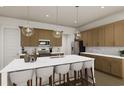 Modern kitchen with island, white quartz countertops, and wood cabinets at 874 Foxtail Dr. # C-36, Longs, SC 29568