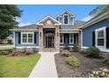 Inviting front entrance with stone accents, well-maintained landscaping, and a decorative front door at 1201 Surf Pointe Dr., North Myrtle Beach, SC 29582