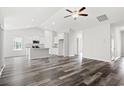 Open living room with high ceilings, hardwood floors, and a view of the kitchen at 197 Six Mile Creek Dr., Georgetown, SC 29440