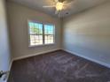 Cozy bedroom featuring a ceiling fan, plush carpeting, and a window with natural light at 2802 Daisy Rd., Loris, SC 29569