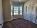 Cozy bedroom featuring a bay window, a double door closet, and plush carpeting at 2814 Daisy Rd., Loris, SC 29569