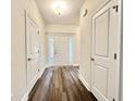 Bright hallway featuring wood floors and white trim with an entryway into the home at 6944 Highway 66, Loris, SC 29569
