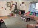 Inviting living room with comfortable furniture, a Christmas tree, fireplace, and natural light from sliding glass door at 100 G Myrtle Greens Dr. # G, Conway, SC 29526