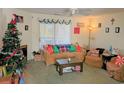 Cozy living room with comfortable furniture, a Christmas tree, and natural light from sliding glass door at 100 G Myrtle Greens Dr. # G, Conway, SC 29526