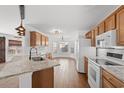 Well-lit kitchen features granite countertops, modern appliances, and a breakfast bar at 2053 Haystack Way, Myrtle Beach, SC 29579