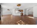 Bright, open-concept living room with wood-look tile floors, modern lighting, and updated kitchen at 2053 Haystack Way, Myrtle Beach, SC 29579