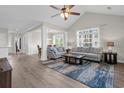 Bright living room boasts vaulted ceiling, ceiling fan, and luxury vinyl plank flooring at 607 Sunnyside Dr. # 201, Murrells Inlet, SC 29576