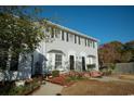 Exterior view of the townhome showcasing tidy landscaping, charming bay window and convenient parking at 2925 Carriage Row Ln. # 145, Myrtle Beach, SC 29577