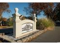 Community entrance sign 'Carriage Row' surrounded by beautiful landscaping and mature trees at 2925 Carriage Row Ln. # 145, Myrtle Beach, SC 29577