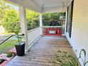 Inviting front porch featuring a red swing, perfect for relaxing and enjoying the outdoors at 306 E Godbold St., Marion, SC 29571