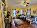 Comfortable living room featuring a ceiling fan, hardwood floors and a relaxing seating arrangement at 306 E Godbold St., Marion, SC 29571
