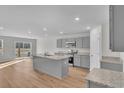 Open-concept kitchen with gray cabinets, island, and stainless steel appliances at 60 Cape Point Dr., Conway, SC 29527