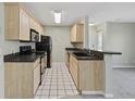 Well-lit kitchen features stainless steel appliances and black countertops at 8830 Chandler Dr. # E, Myrtle Beach, SC 29575
