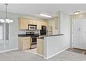 Efficient kitchen layout with stainless steel appliances, ample cabinetry, and breakfast bar at 8830 Chandler Dr. # E, Myrtle Beach, SC 29575