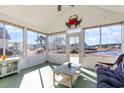 Bright sun room with views of the lake, a ceiling fan, and plenty of windows at 1133 Spalding Ct., Surfside Beach, SC 29575