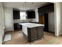 Modern kitchen featuring dark cabinetry, white countertops, and a large island at 1241 Crested Iris Way, North Myrtle Beach, SC 29582