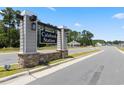 Welcome to Calabash Station! Community entrance sign with stone base, lighting, and landscaped median at 1217 Nw Calabash Station Blvd., Calabash, NC 28467