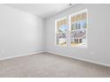 Cozy bedroom with plush carpet and two bright windows overlooking the neighborhood at 1233 Nw Calabash Station Blvd., Calabash, NC 28467