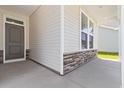 Inviting front porch with stone accents and a stylish front door, adding curb appeal at 1233 Nw Calabash Station Blvd., Calabash, NC 28467