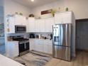 Well-appointed kitchen with white cabinets, stainless steel appliances, and tile backsplash at 3070 Sutherland Dr., Little River, SC 29566