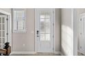 Bright foyer featuring a white front door with glass panes and a window with blinds at 377 Starlit Way, Myrtle Beach, SC 29579