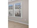 Bright room with neutral walls, modern flooring, and windows overlooking the backyard at 377 Starlit Way, Myrtle Beach, SC 29579