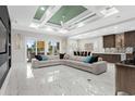 Spacious living room boasts marble floors, coffered ceilings, and lots of natural light at 6105 Bolsena Place, Myrtle Beach, SC 29577