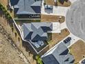 Aerial view of a home and surrounding neighborhood, showcasing backyard with hot tub and patio furniture at 724 Hobonny Loop, Longs, SC 29568