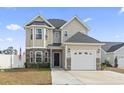 Charming home with stone accents, well-maintained landscaping, and an American flag displayed at 724 Hobonny Loop, Longs, SC 29568