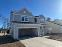 Two-story house with gray siding, attached garage, and landscaping at 3080 Palma Way, Myrtle Beach, SC 29579
