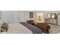 Serene main bedroom with hardwood floors, a dresser, and a view into the ensuite bathroom at 574 Haven View Way, Murrells Inlet, SC 29576