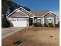 Beautiful one-story home with fresh landscaping, neutral siding, brick detail, and attached garage at 741 Londonberry Ct., Conway, SC 29526